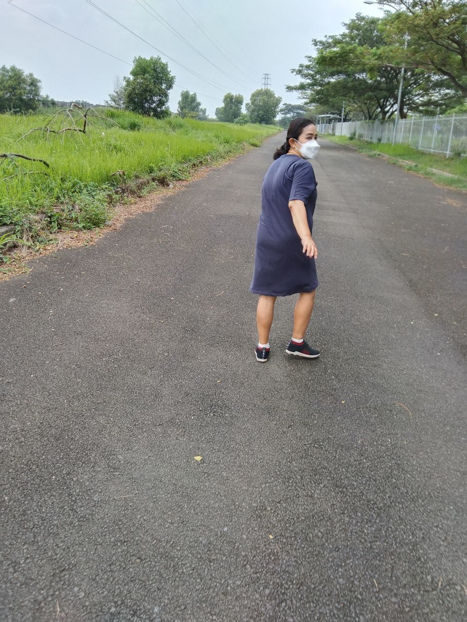 one person, full length, road, asphalt, transportation, day, casual clothing, plant, rear view, lifestyles, nature, adult, leisure activity, the way forward, tree, sky, men, road surface, sports, city, outdoors, walking, tarmac, standing, street, motion, young adult