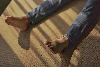 Low section of man relaxing on floor at home