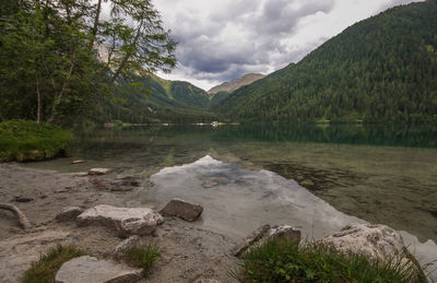 Scenic view of lake by mountains against sky