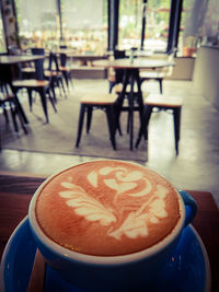 Close-up of cappuccino served on table