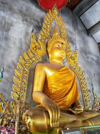 Statue of buddha against building