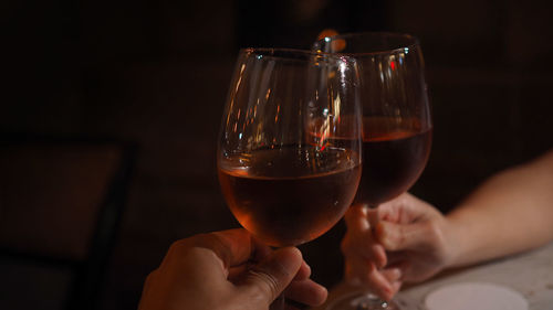 Midsection of man holding wineglass