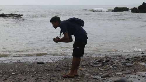 Side view of man standing on beach