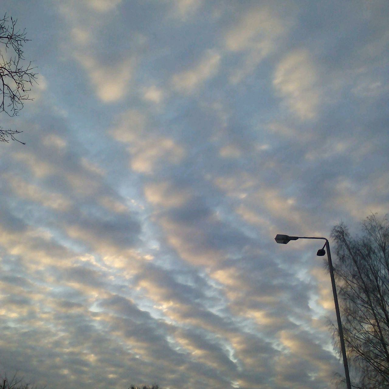 sky, cloud - sky, low angle view, cloudy, silhouette, sunset, cloud, weather, nature, beauty in nature, tranquility, scenics, overcast, cloudscape, outdoors, no people, tranquil scene, dusk, flying, transportation