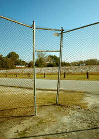 Fence on field against clear sky