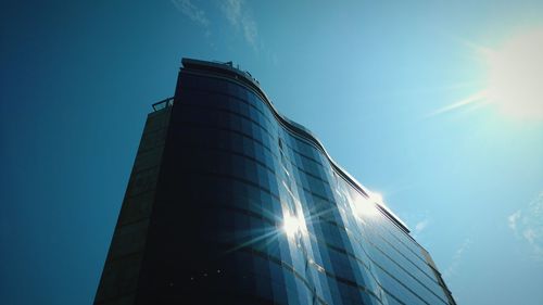 Low angle view of building against sky on sunny day