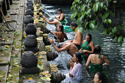 People waiting for bath in fountain at temple