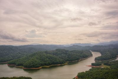 Scenic view of river and mountains against sky