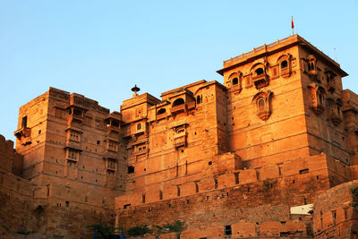 Low angle view of historic building against clear blue sky