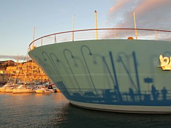 Boats in sea at sunset