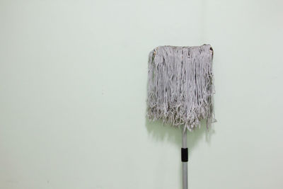 Close-up of mop against wall