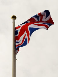 Low angle view of flag against clear sky