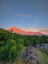 Beautiful morning view of an ancient village and the mighty mount rinjani, lombok indonesia