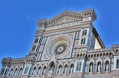 Low angle view of historical building against blue sky