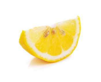 Close-up of orange slice against white background