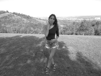 Portrait of young woman standing on land