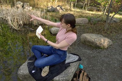 Side view of a girl sitting on plant