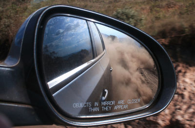 Reflection of side-view mirror of car