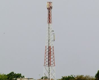 Low angle view of communications tower against sky