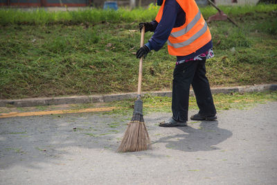 Man sweeping on road