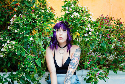 Thoughtful woman sitting alone outdoors. young worried in backyard