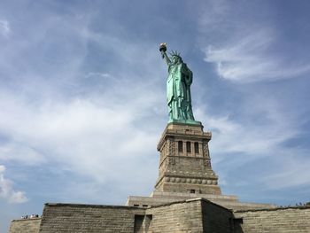 Low angle view of statue against cloudy sky