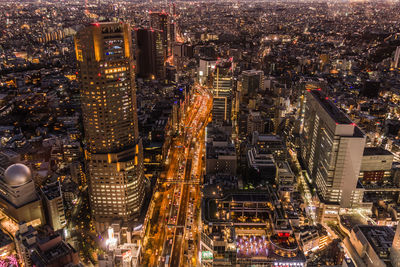 High angle view of illuminated modern buildings in city at night