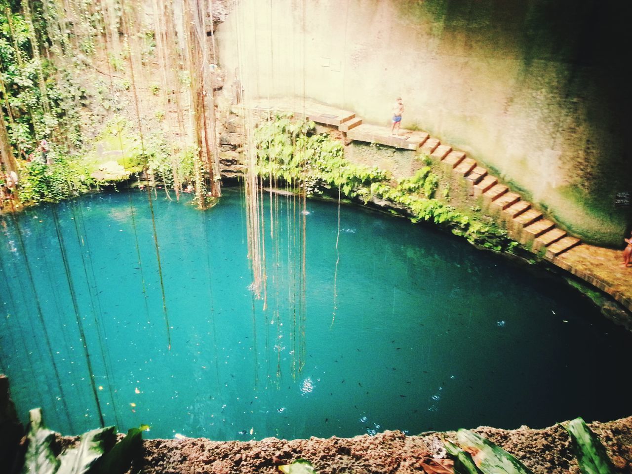 HIGH ANGLE VIEW OF RIVER FLOWING THROUGH STONE WALL