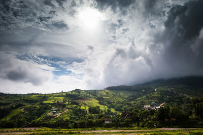 View of green mountains against sky