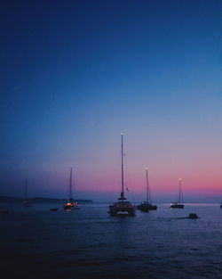 Sailboats in sea against sky during sunset in the port of komiža in croatia. 