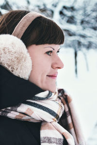 Portrait of smiling girl looking away during winter