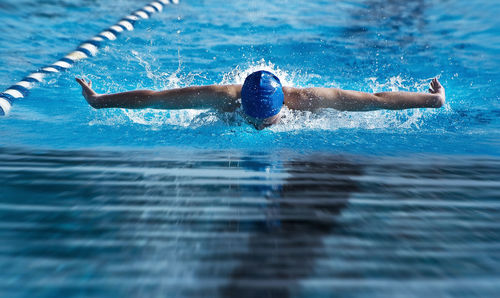 Person swimming in swimming pool