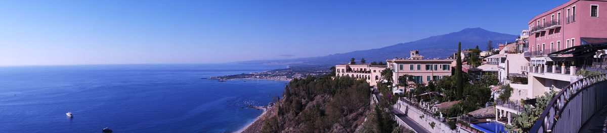 Panoramic view of sea and buildings against sky