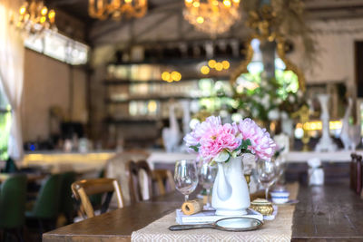 Flower vase on table in cafe