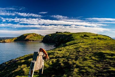 Scenic view of mountain and sea against sky