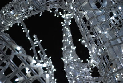 Low angle view of lit lights at night