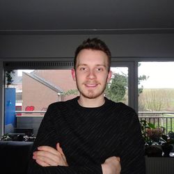 Portrait of young man standing at home