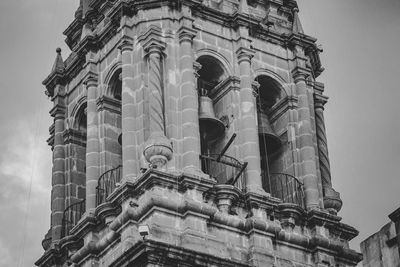 Low angle view of sculptures on building against sky