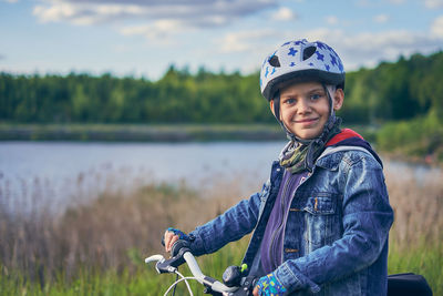 Portrait of smiling man riding bicycle on field