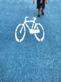 Low section of man standing on road