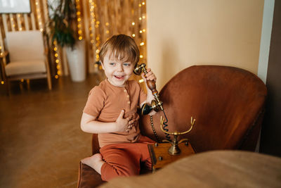 Little boy with antique phone. high quality photo