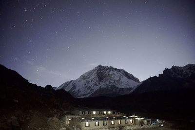 Scenic view of illuminated mountains against sky at night