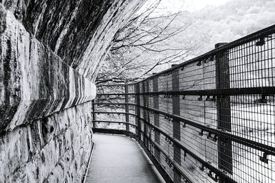 Footbridge over river against sky