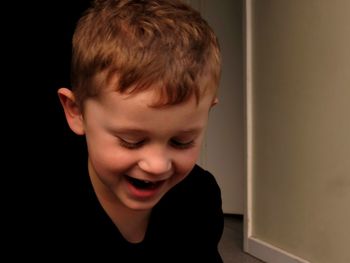 Close-up of smiling boy at home