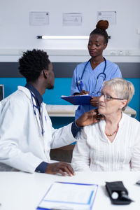 Healthcare worker assisting patient in clinic