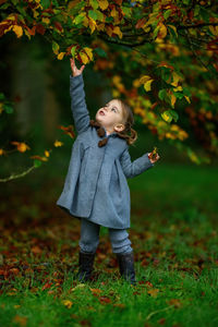Portrait of boy standing on field