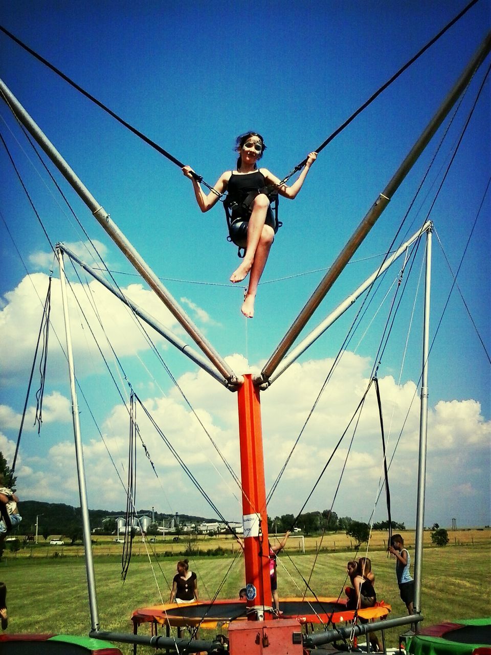 full length, leisure activity, lifestyles, fun, mid-air, enjoyment, sky, young adult, casual clothing, person, jumping, childhood, transportation, blue, clear sky, vacations, day, arms outstretched