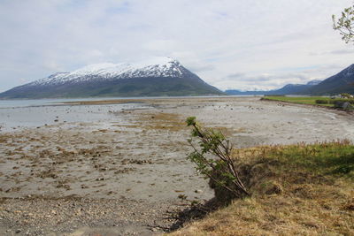 Scenic view of mountains against cloudy sky