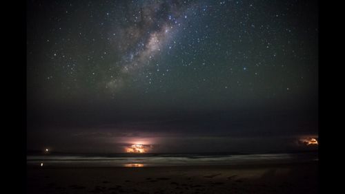 Scenic view of landscape against sky at night