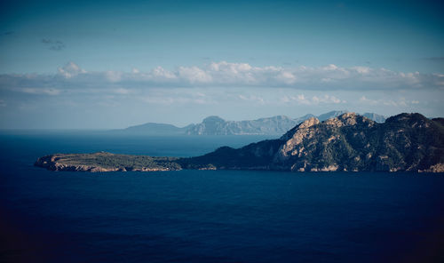 Scenic view of sea and mountains against sky